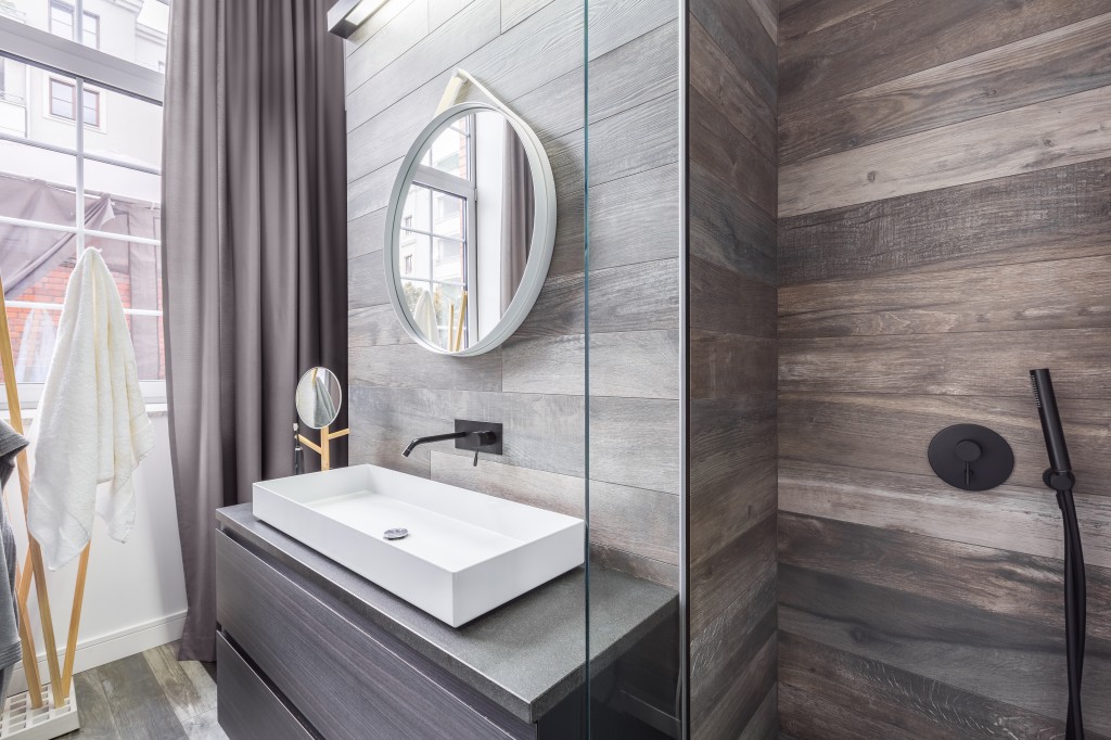 Bathroom with shower and basin with wood effect. 
