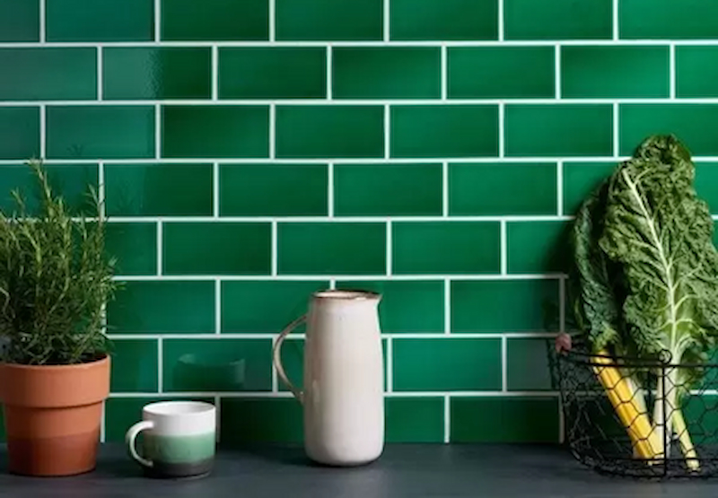 green tiled wall with decorative counter top features