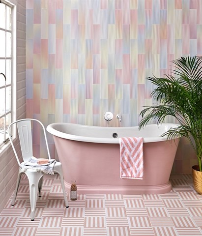 A pink bath tub in a pink bathroom